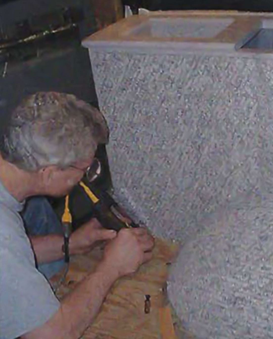The carpet is glued and stapled to the passenger side cabinet and wheel well.