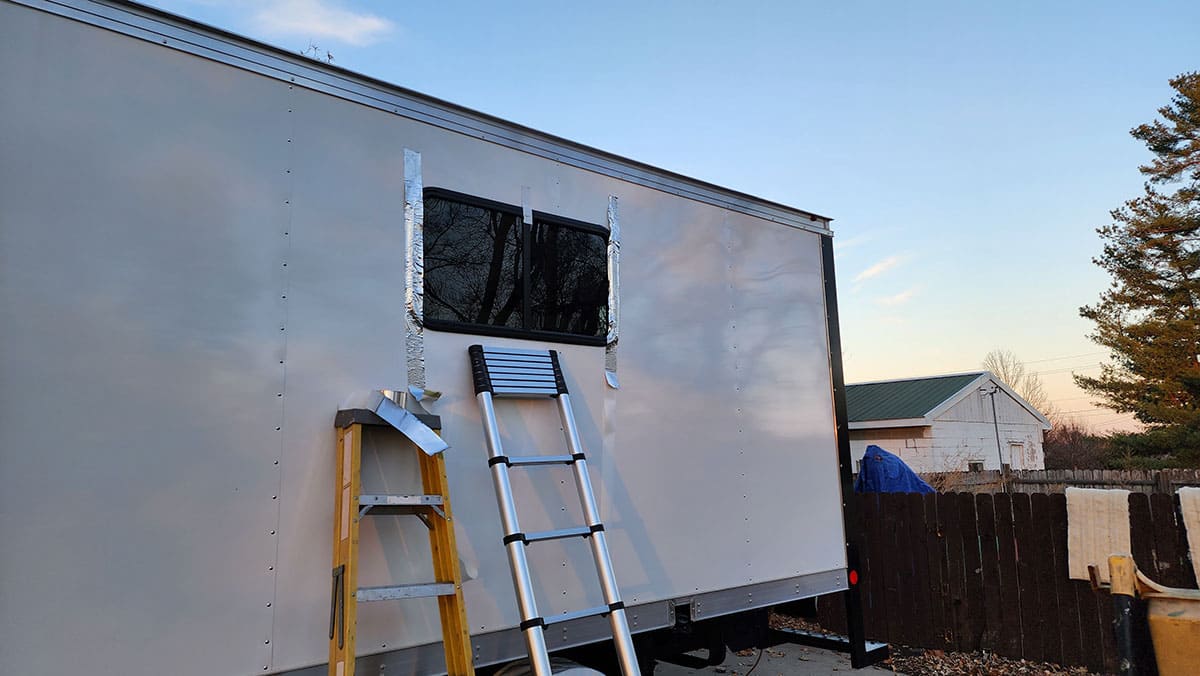 Window in place on driver’s side. The aluminum tape was used to hold the window in place until it could be fully secured on the inside.