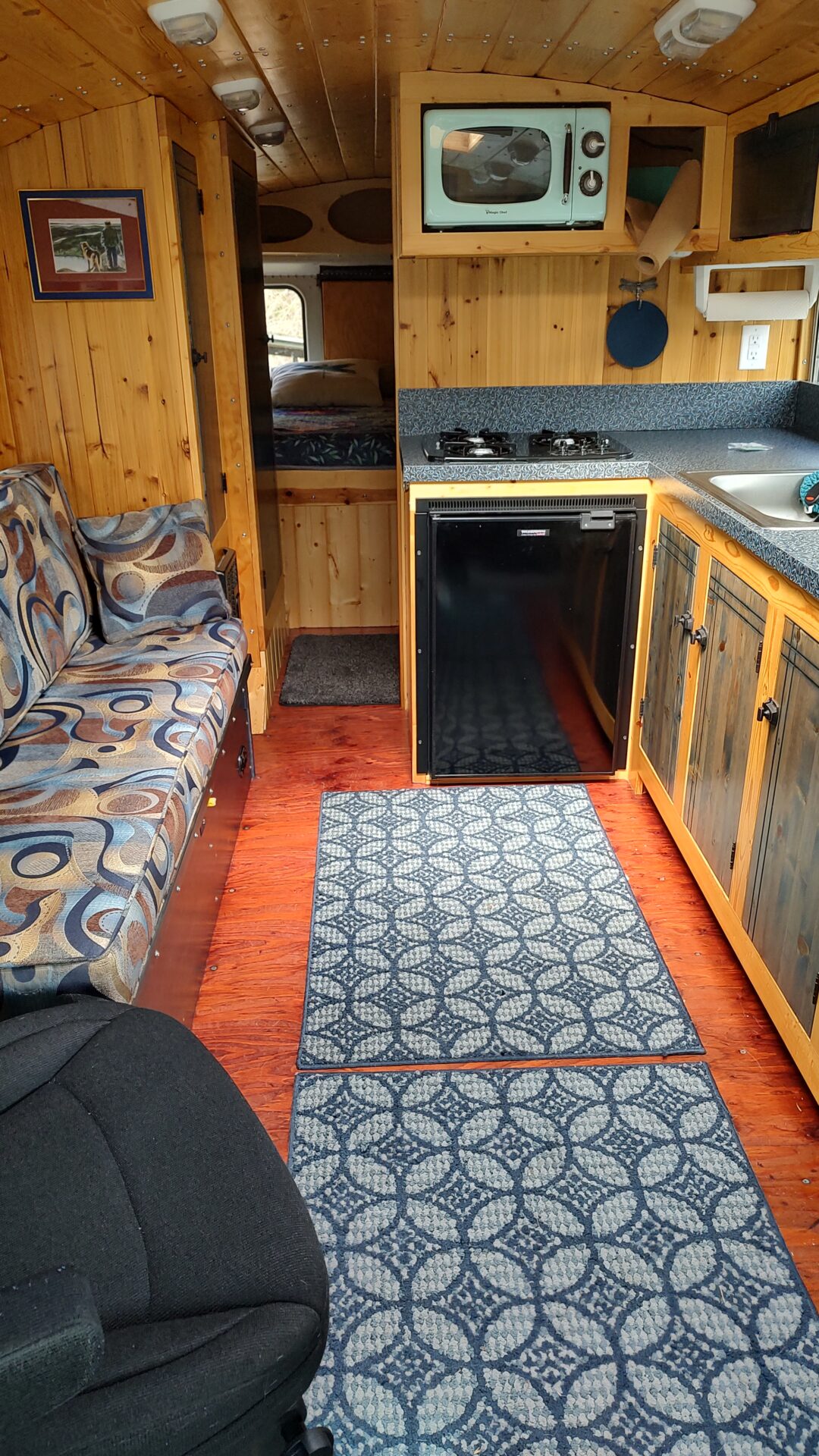 19 Living room and kitchen with swiveling passenger seat. Driver's seat swivels 180 degrees, too Miles, the Bus – A 28’ 2005 Freightliner/Thomas FS-65 - bus conversion photo