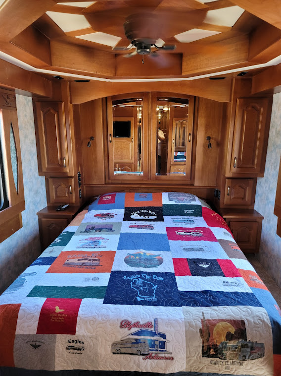 The bedroom. Notice the bedspread and ceiling.