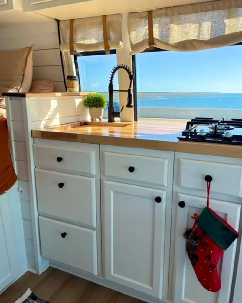 Our completed kitchen. We used a butcher block for the counter. The 2-burner stove and sink are from Amazon.