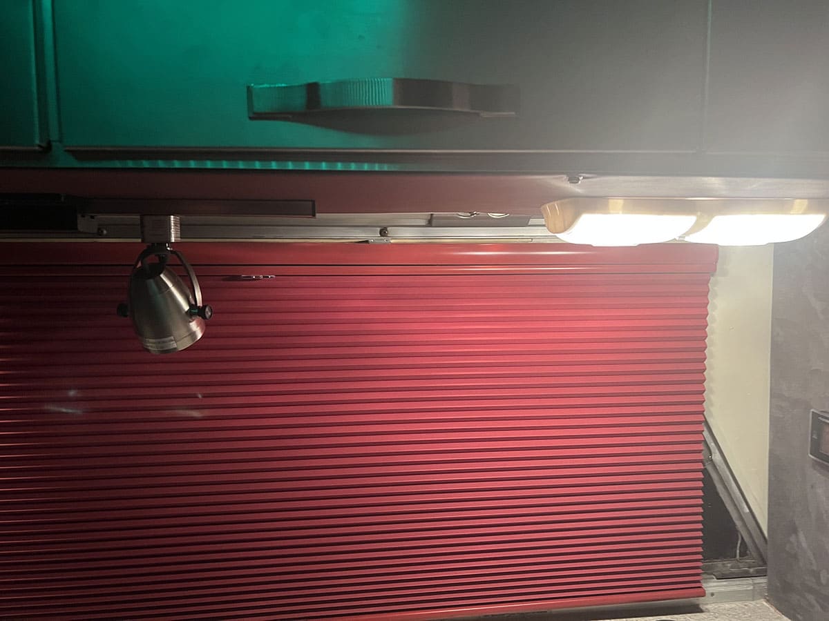 Swiveling study lights for the desk were chosen to match the cabinetry's style. The desk is 110 volts and runs off either shore power or a generator.