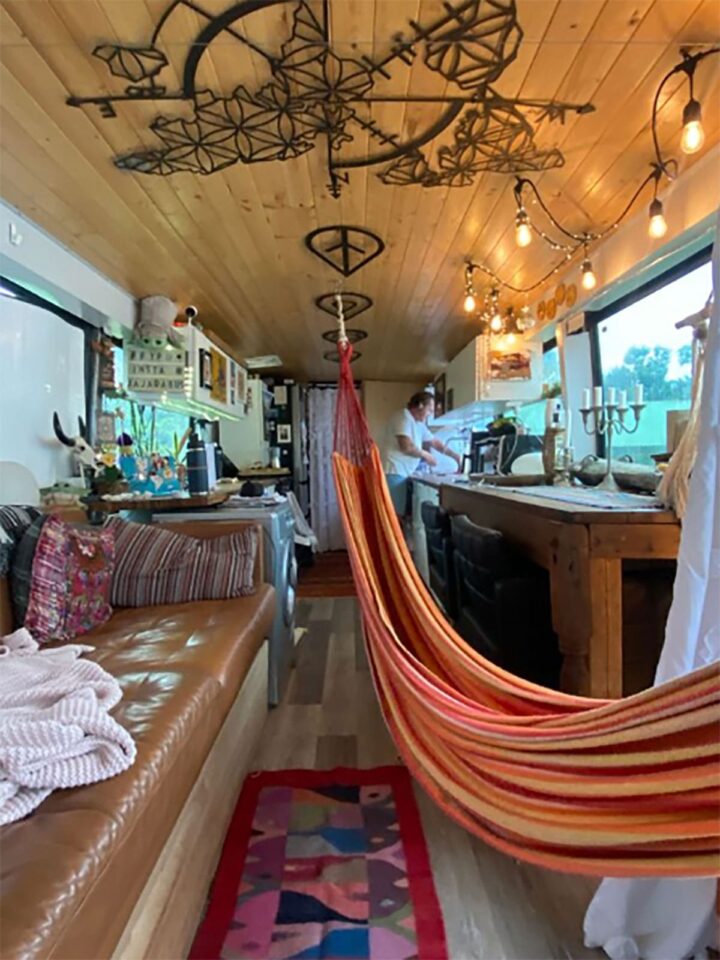 You can see from the living room to the kitchen; I really like the Boho-chic vibe with the hammock and the interior design.